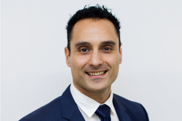 Connect Partners - Anthony L Man in suit smiling at the camera